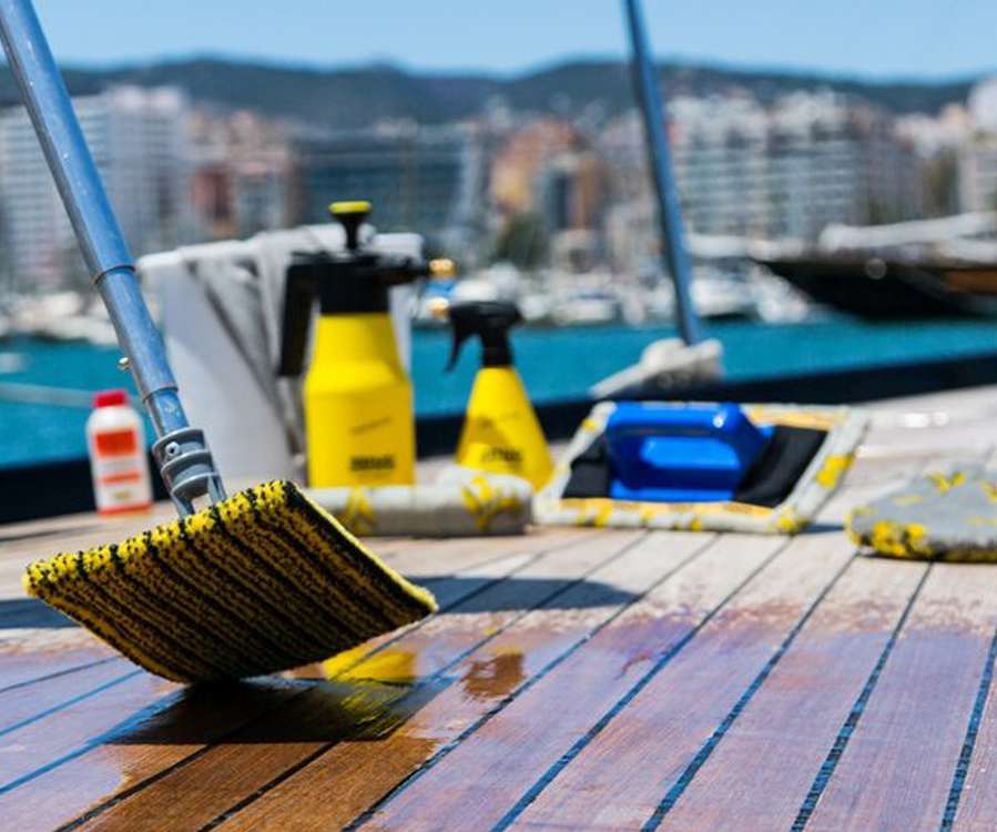 Marine technician polishing the gelcoat of a yacht hull