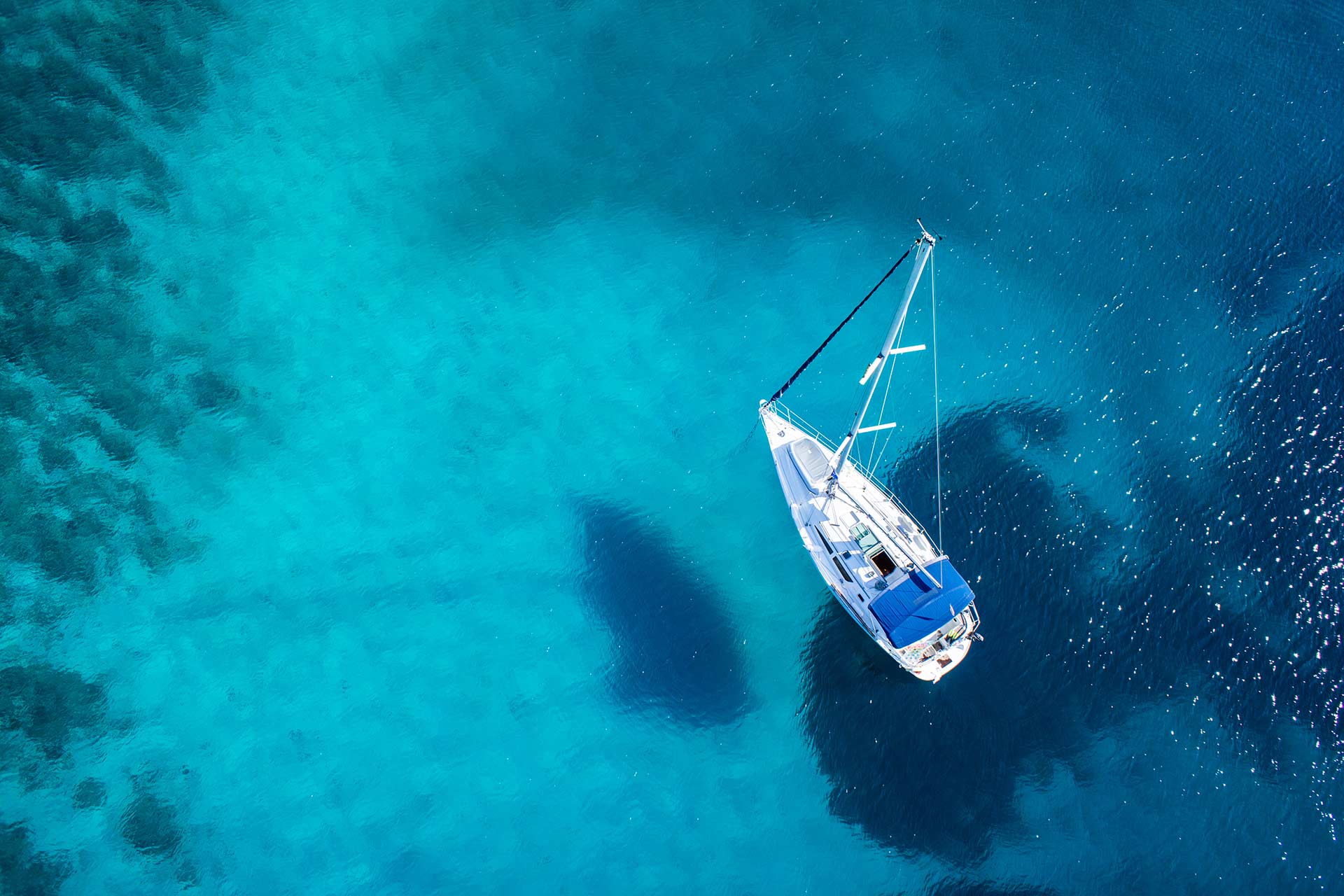 Sailing yacht cruising through clear Mediterranean water